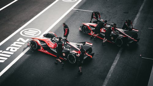 Pit Crew Standing Beside Sports Cars