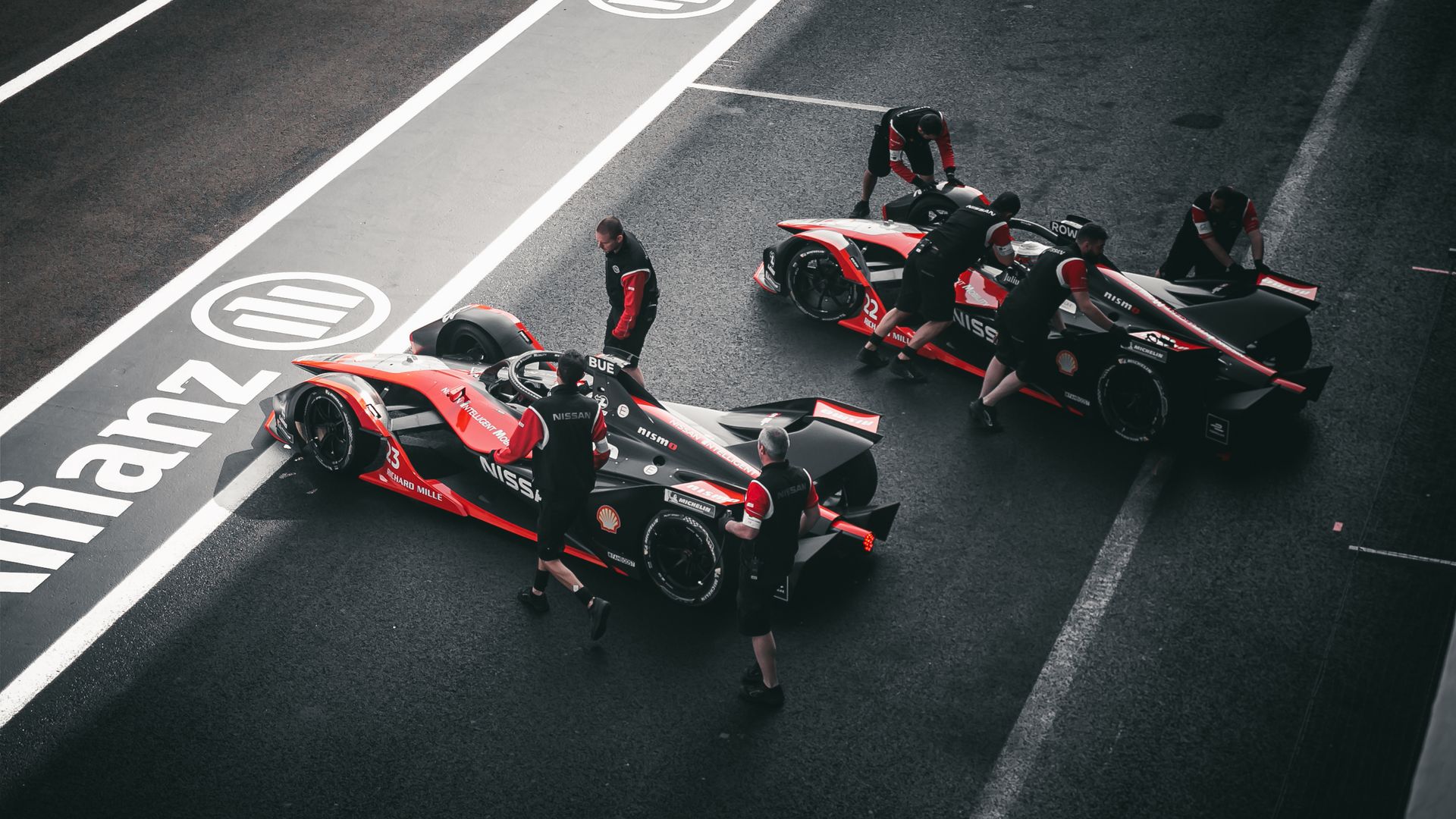Pit Crew Standing Beside Sports Cars