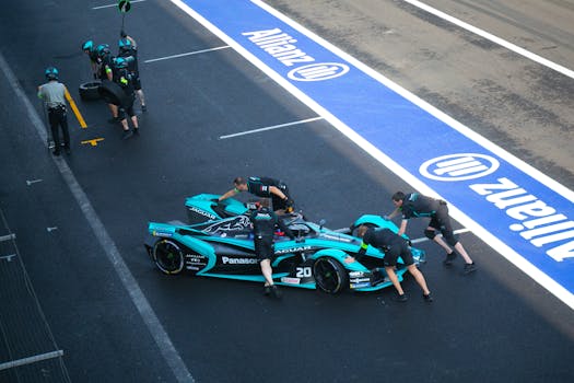 Pit crew prepares Formula E race car for competition in Mexico City pit stop.