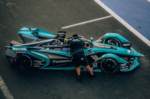 Man Leaning on a Race Car