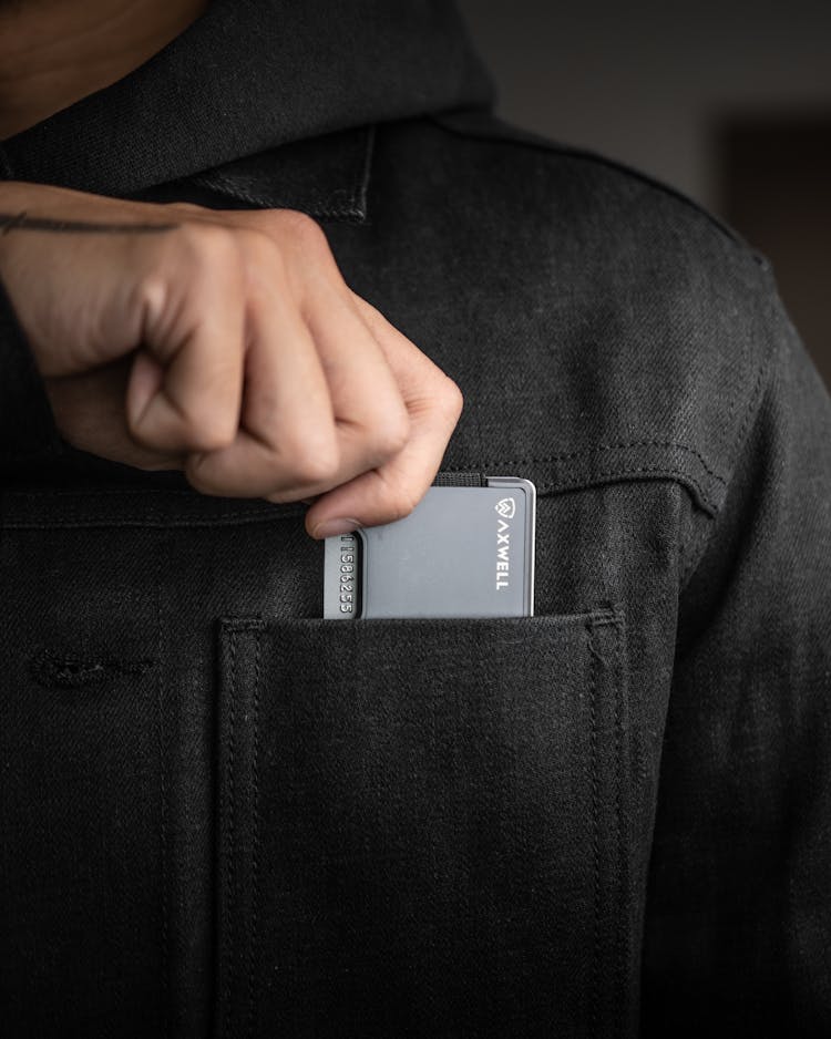 Close-Up Shot Of A Person Holding A Metal Wallet