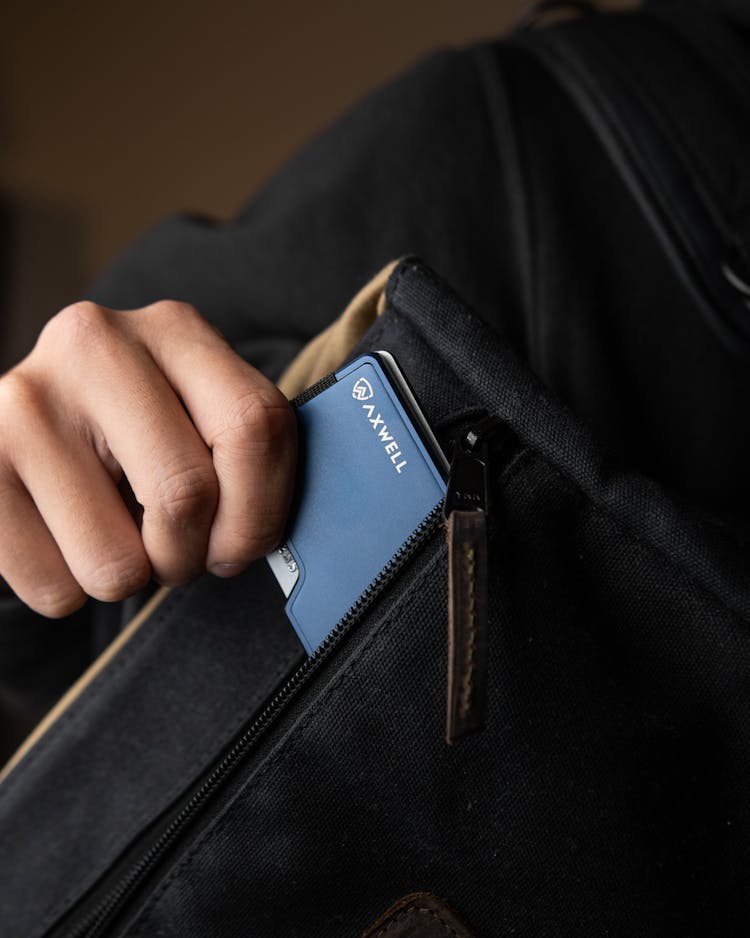 Close-Up Shot Of A Person Holding A Metal Wallet