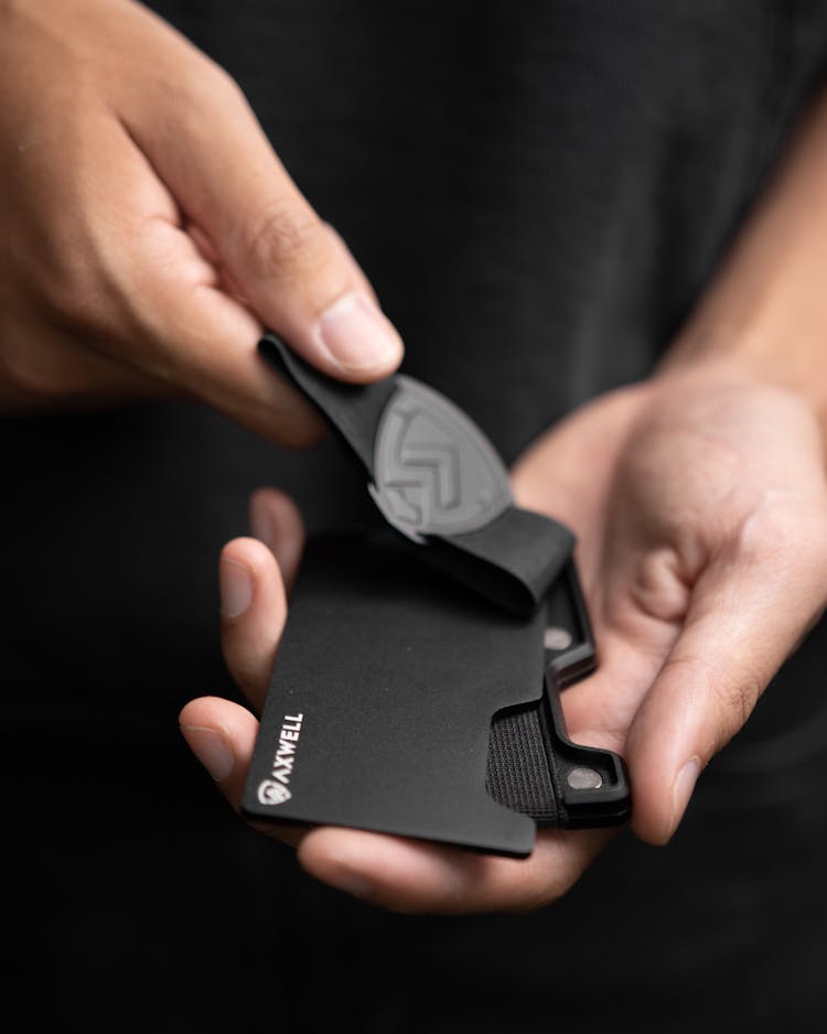 Close-Up Shot Of A Person Holding A Metal Wallet