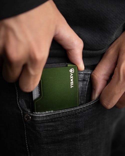 Close-Up Shot of a Person Holding a Metal Wallet
