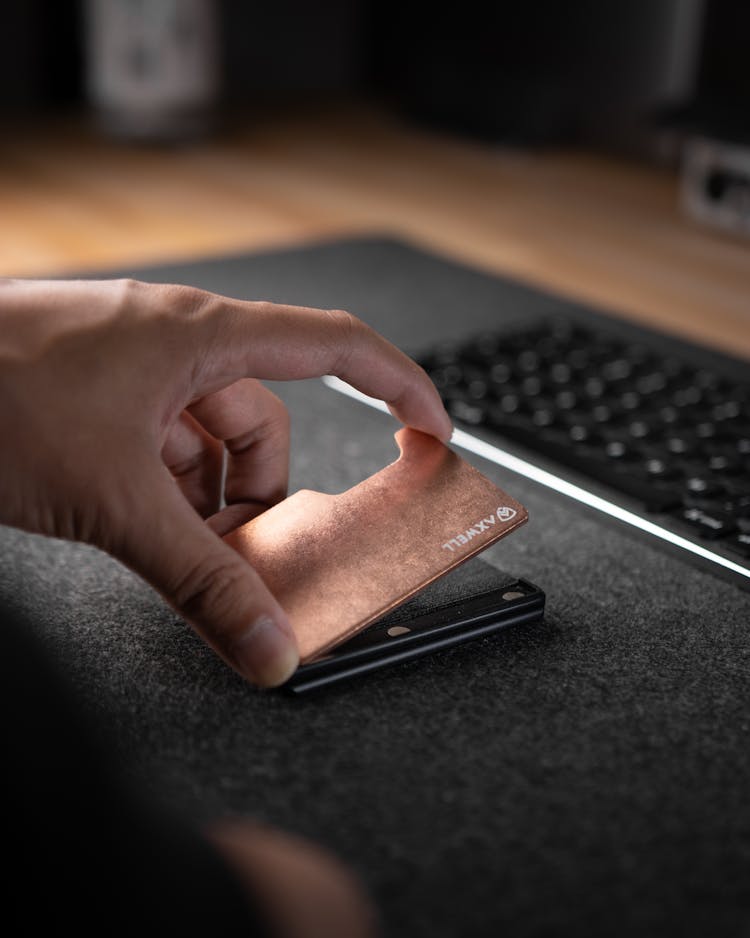 Close-Up Shot Of A Person Holding A Metal Wallet