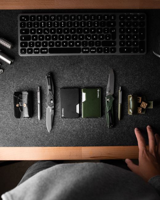 U.S. Military Veteran placing a simple phone, wallet, and keys into a minimalist bag, illustrating the 'Three-Pocket Reality Check' concept