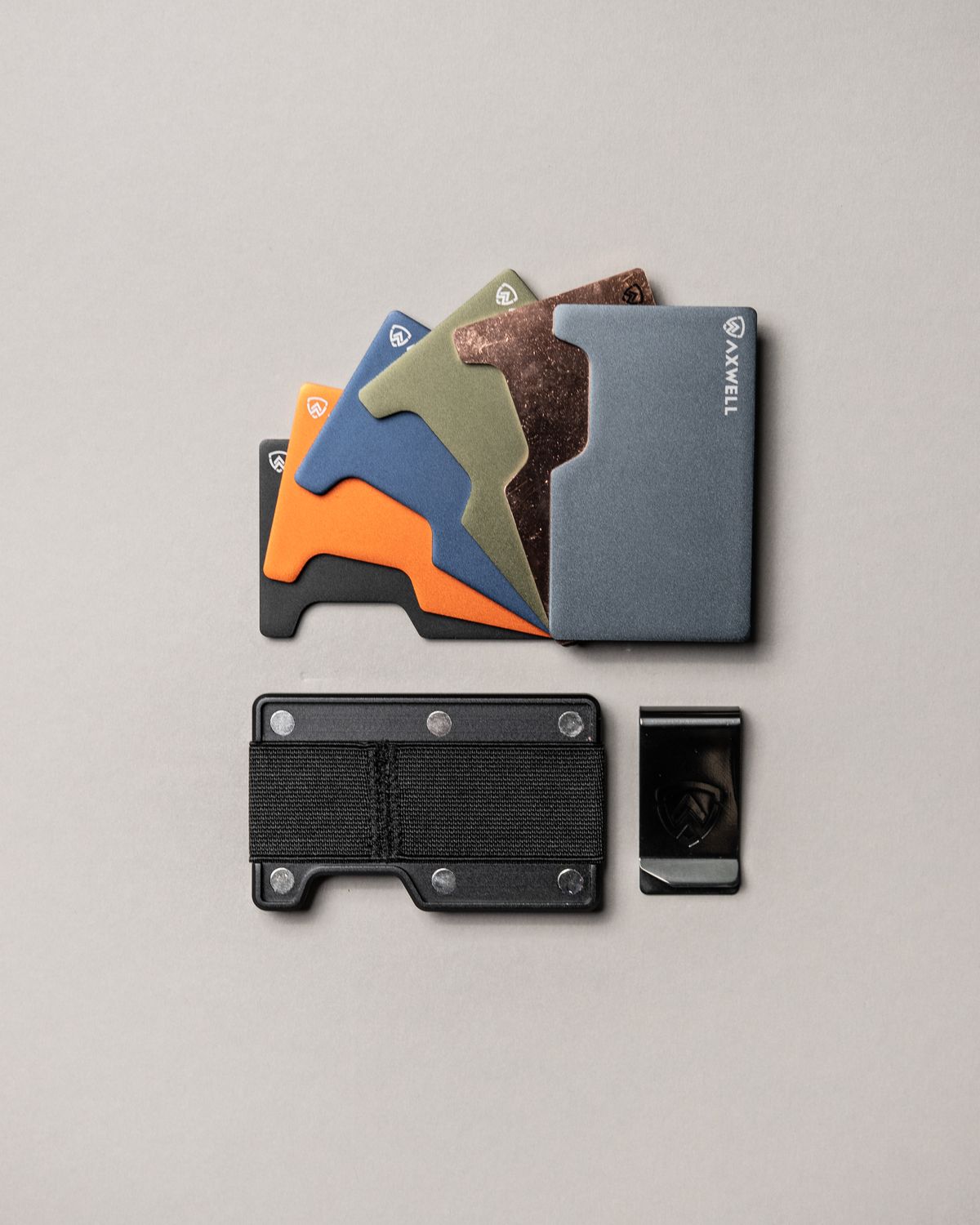 Metasl Wallet A Collection of Metal Wallets Lying on White Surface · Free Stock Photo