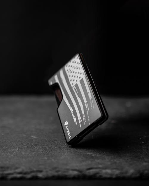 Close-Up Shot of an Edc Wallet on Black Surface
