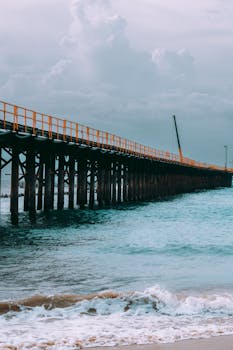 A tranquil view of a wooden pier extending into the ocean, captured in Paracuru, Brazil.