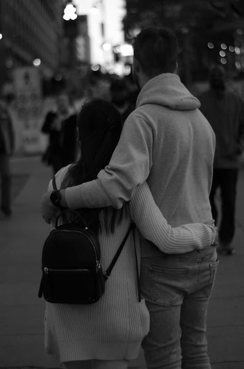 Grayscale Photo of Woman and Man Hugging