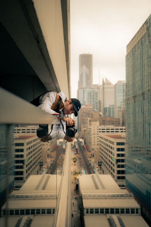 Free Photographer captures cityscape from high-rise with Canon camera. Stock Photo