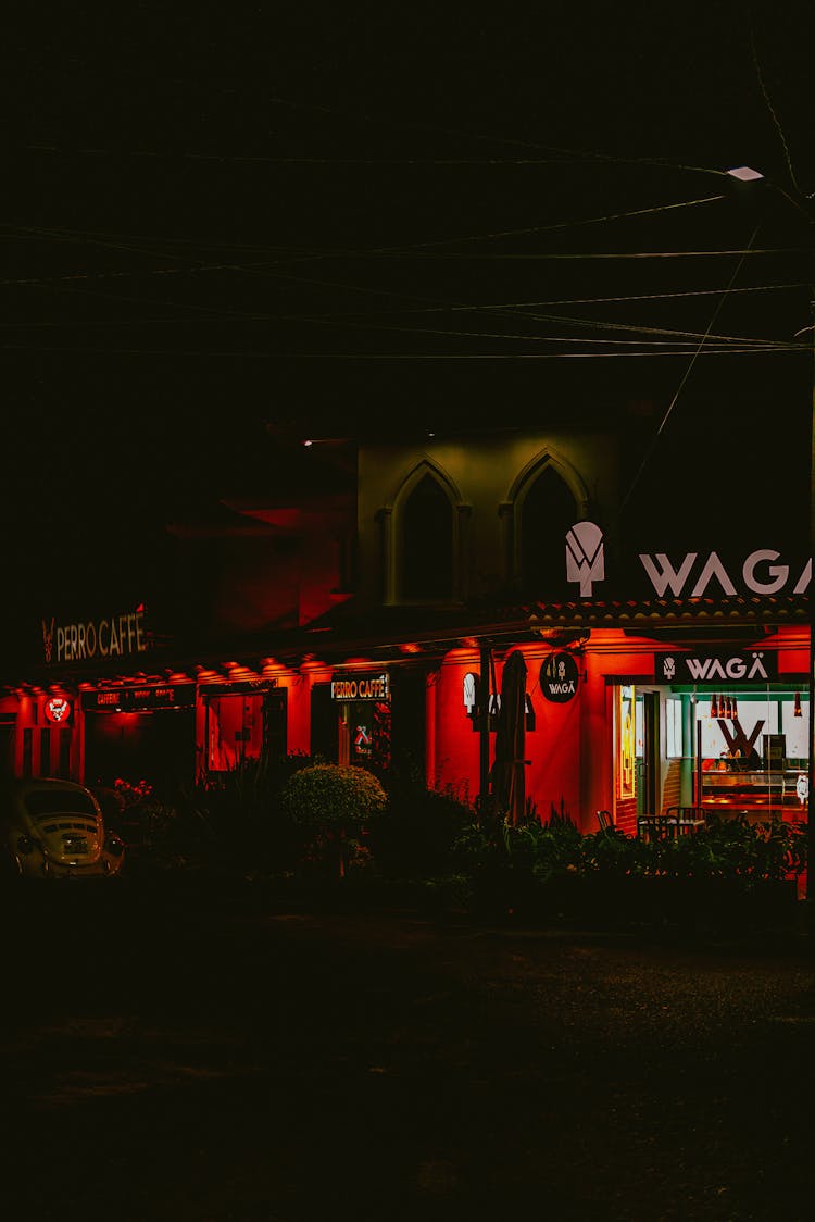 Restaurant In Lights On Dark Night Street