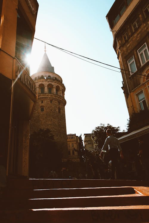 Man Walking next to the Galata Tower in Istanbul