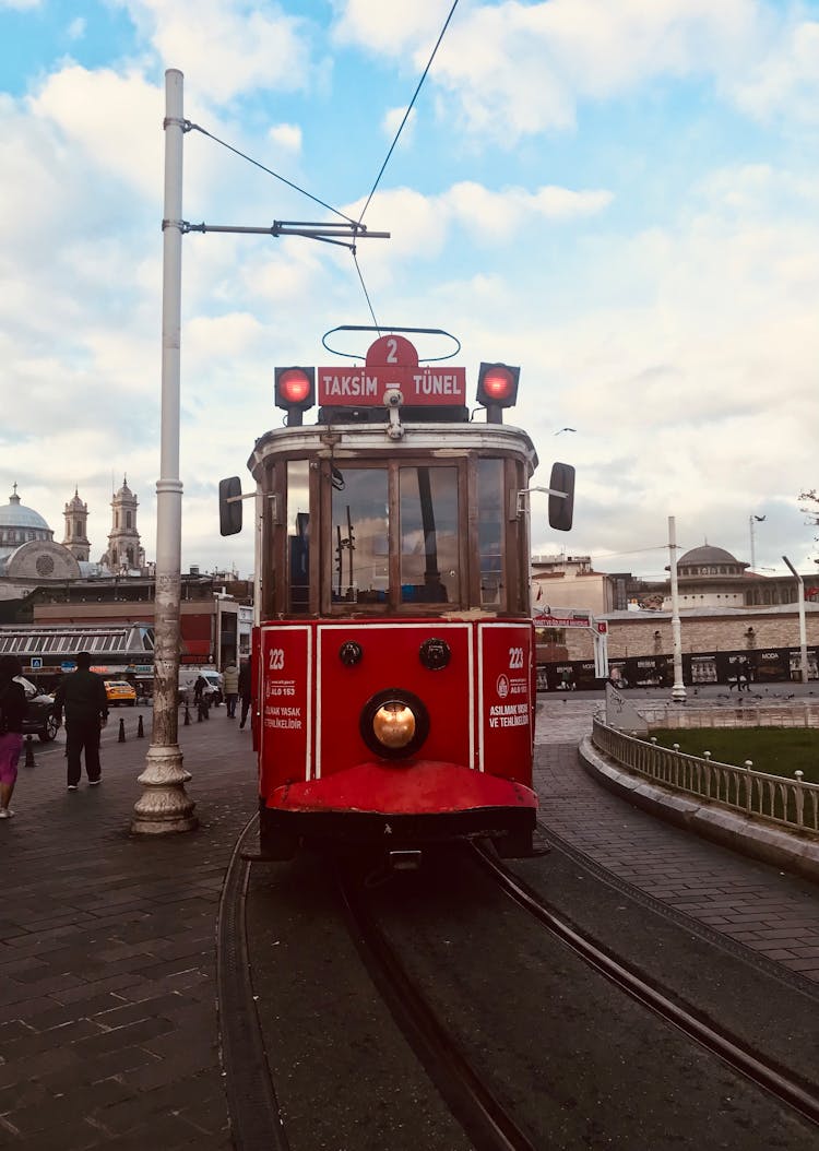 A Moving Red Tramway On The Road 