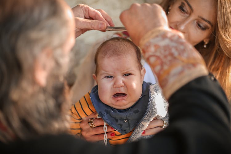 A Woman Carrying A Crying Baby 