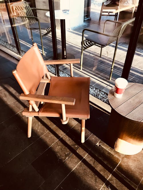 Free Coffee in Takeaway Cup on Cafe Wooden Table Stock Photo