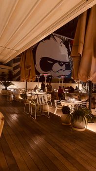 Elegant outdoor restaurant setting in Istanbul, featuring modern decor and vibrant ambiance at night.
