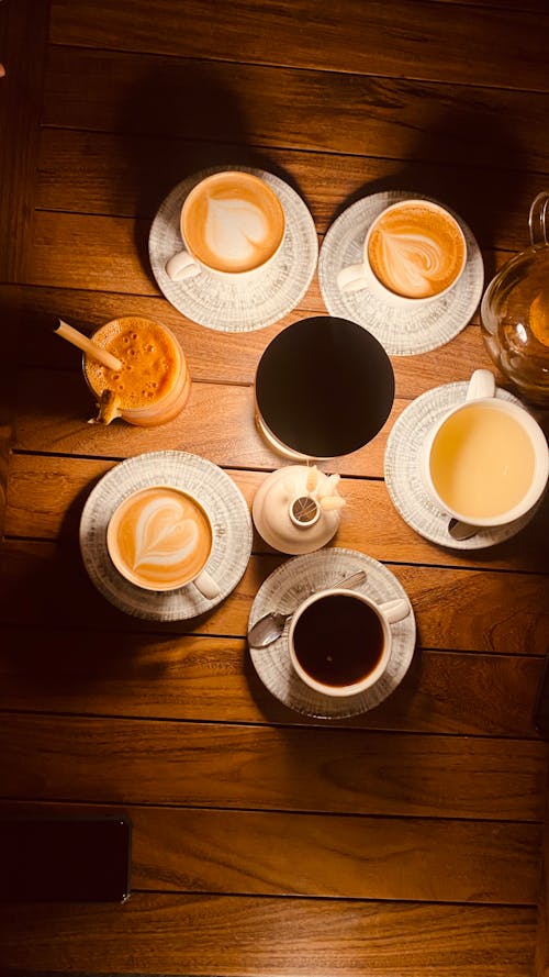 Top View Shot of Cups of Coffee on a Wooden Surface