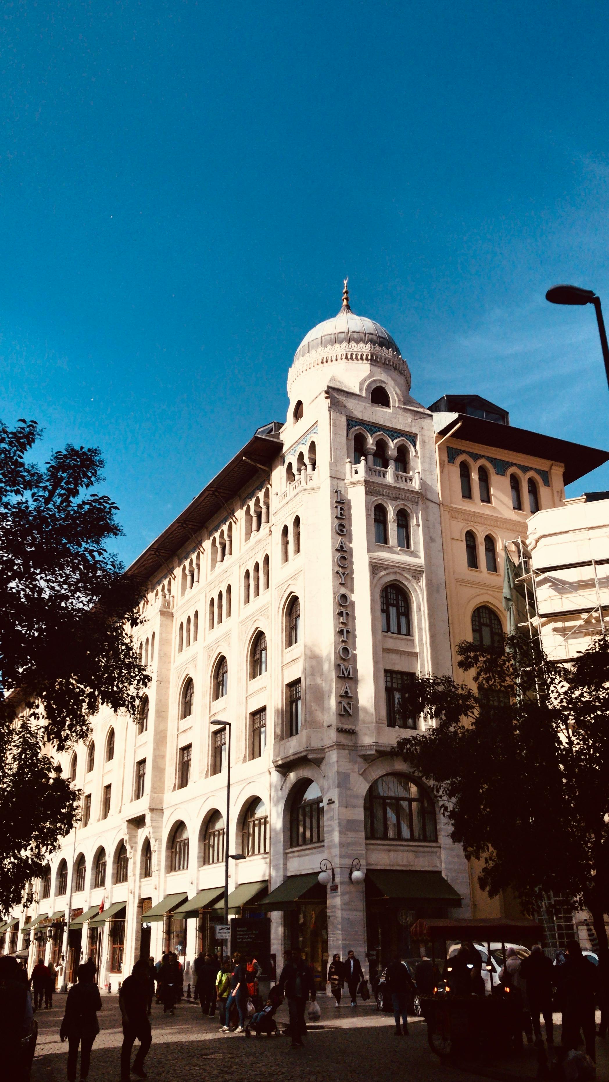 Elegant historic building with a dome in the bustling streets of Istanbul, Turkey.