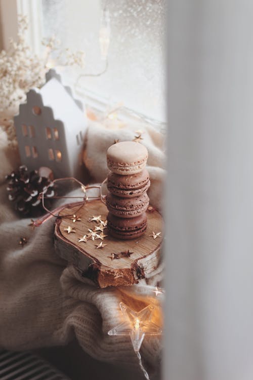 Stack of Macarons and a Pair of Glasses on a Sweater