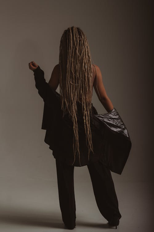 Back View Shot of a Woman with Dreadlocks Hair Wearing Black Blazer and Black Pants