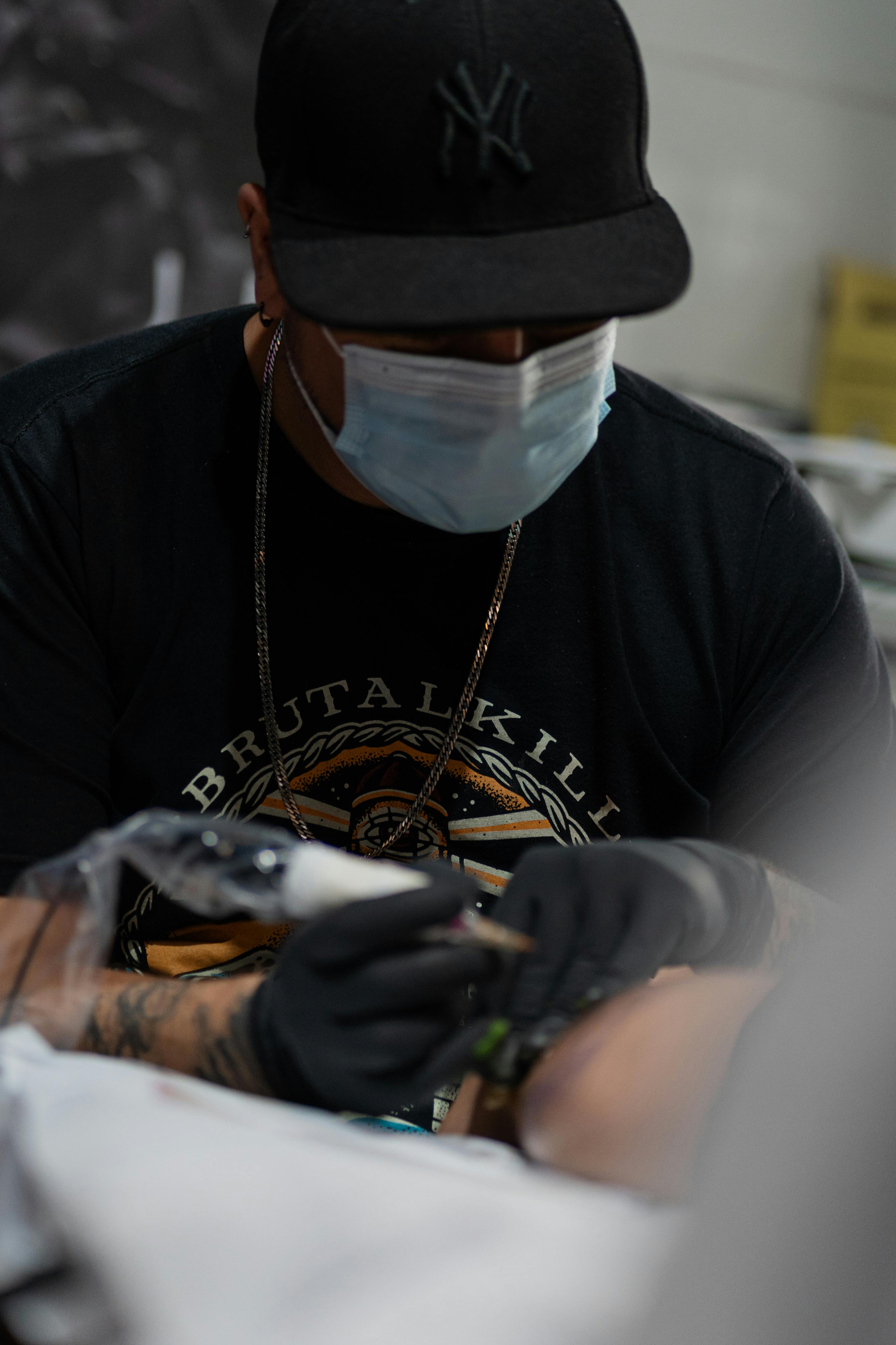 Man in Gloves Making Tattoo with Machine · Free Stock Photo