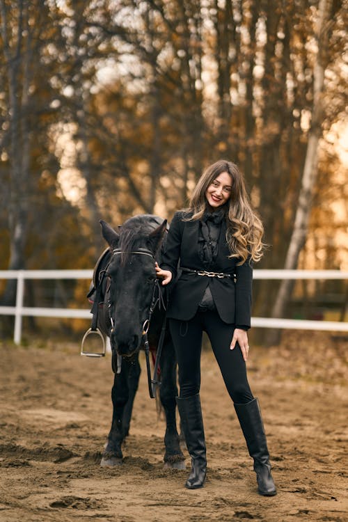 Woman Standing Beside a Horse
