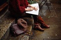 Woman Sitting While Holding Book
