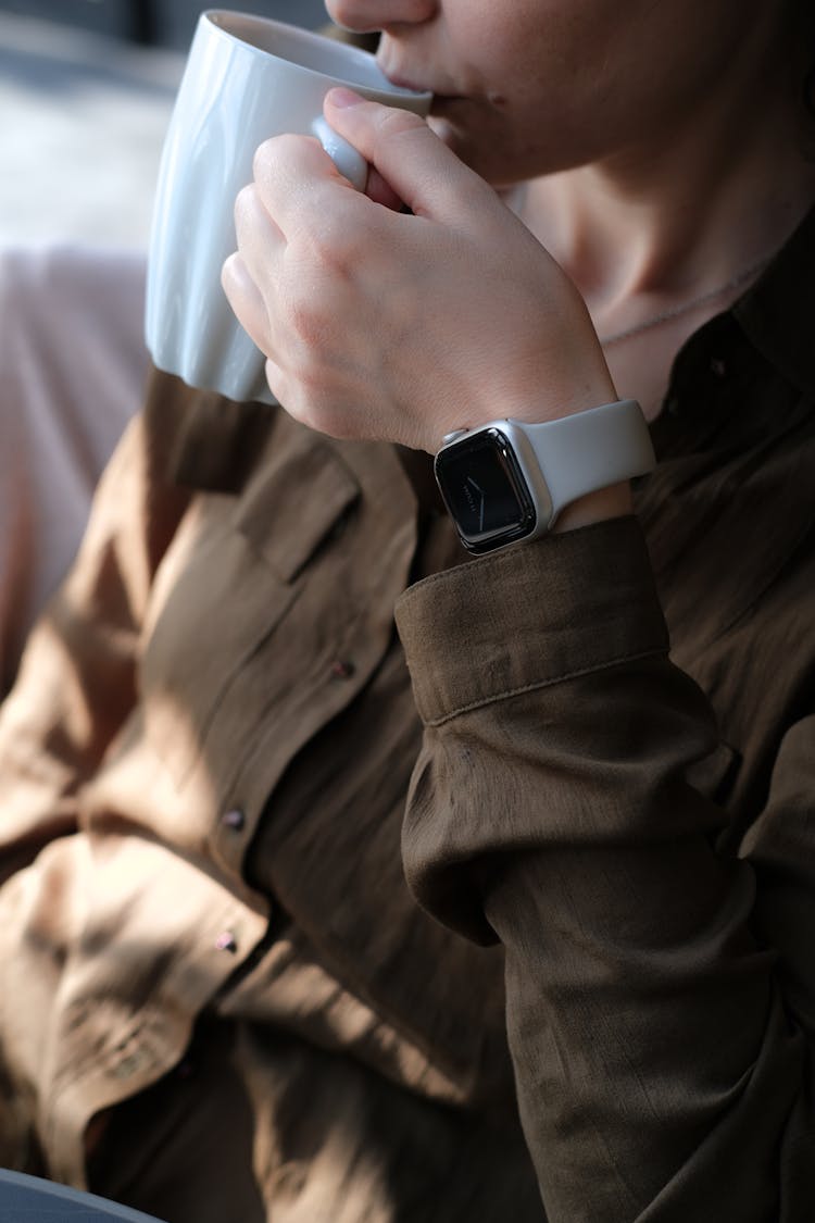 A Woman Drinking From A Mug