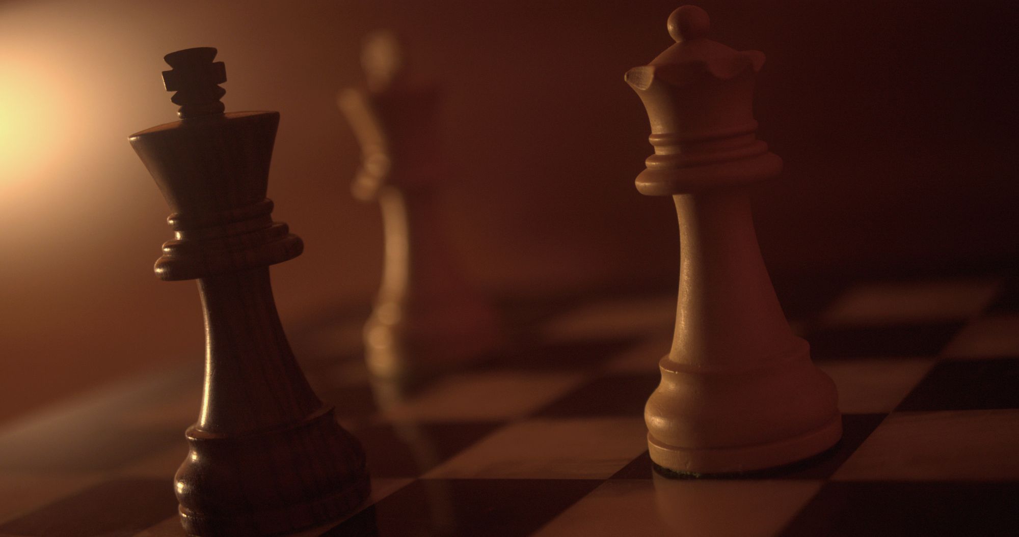 Chess pieces in dramatic light