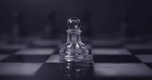 Free Glass Chess Pawn on Chess Board Stock Photo