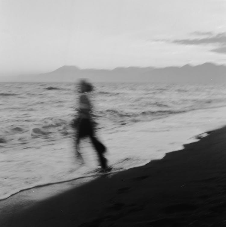 Blurred Picture Of A Person Running Into The Sea 