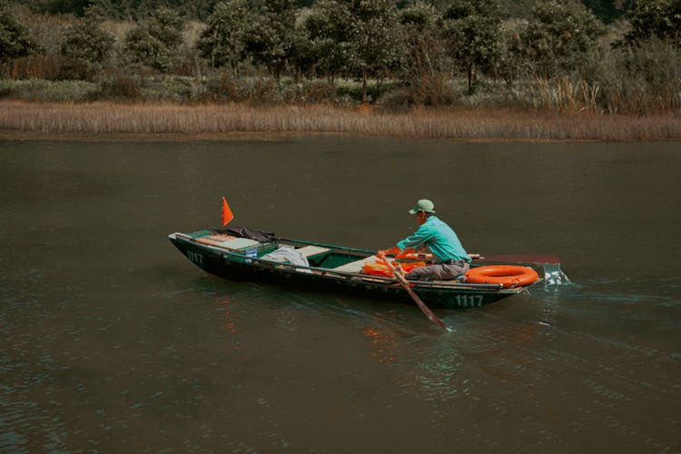 A Man Rowing A Boat