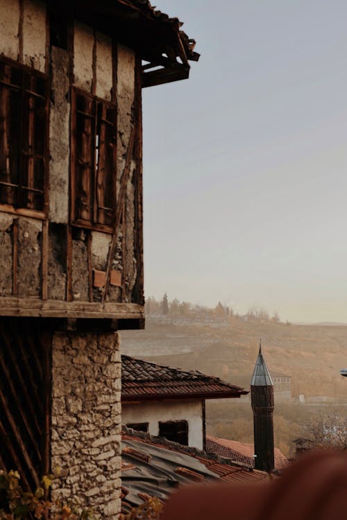 Weathered Traditional Architecture and Mist on a Hill