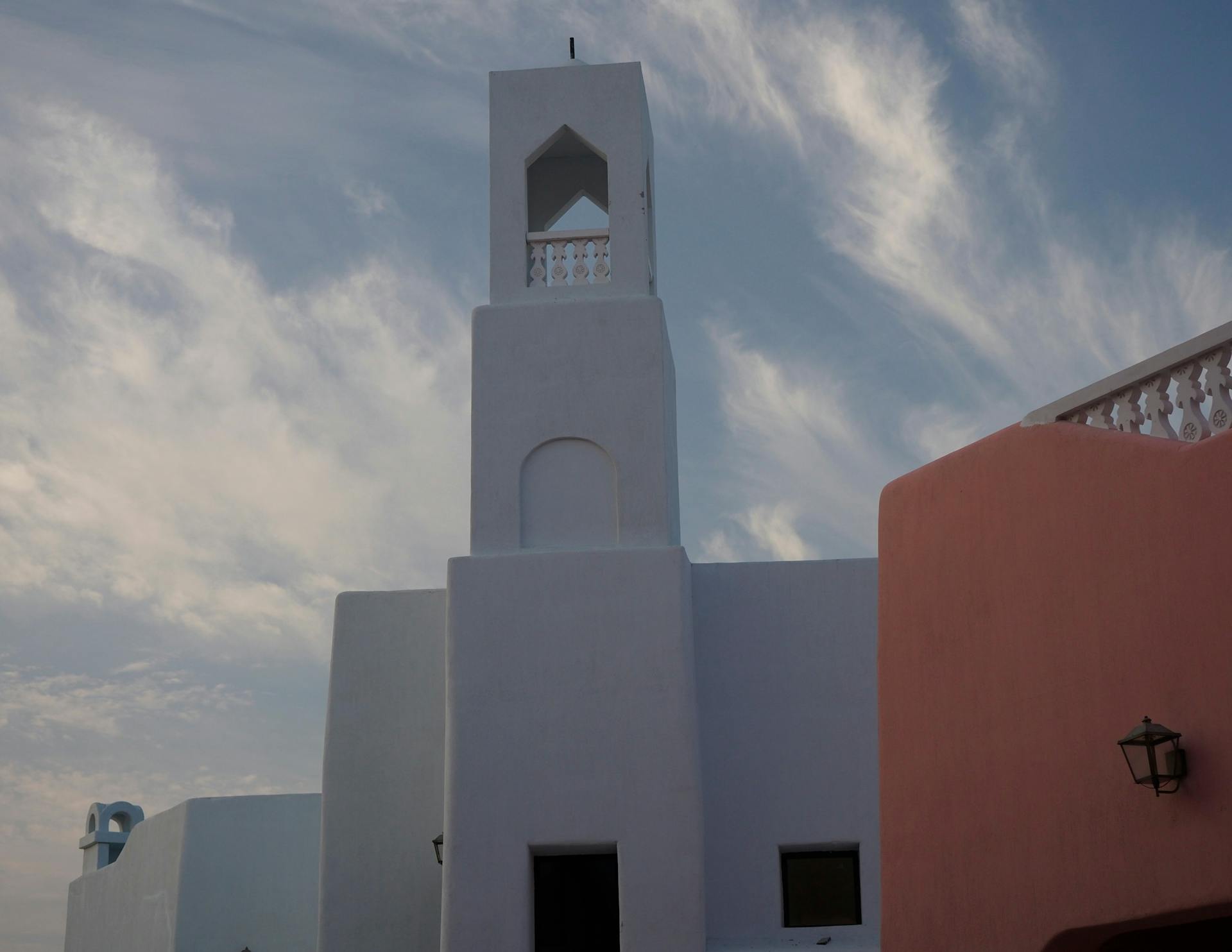 A striking modern building in Doha, Qatar against a dramatic blue sky.