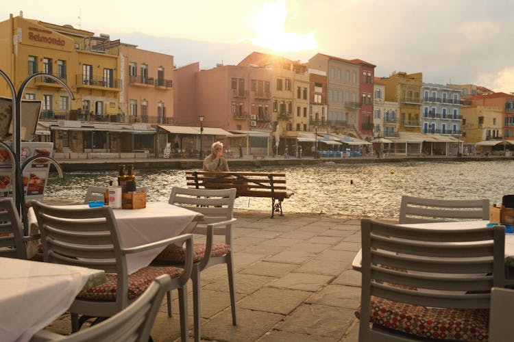 Cafe Tables Near Sea In Coastal Town On Sunset