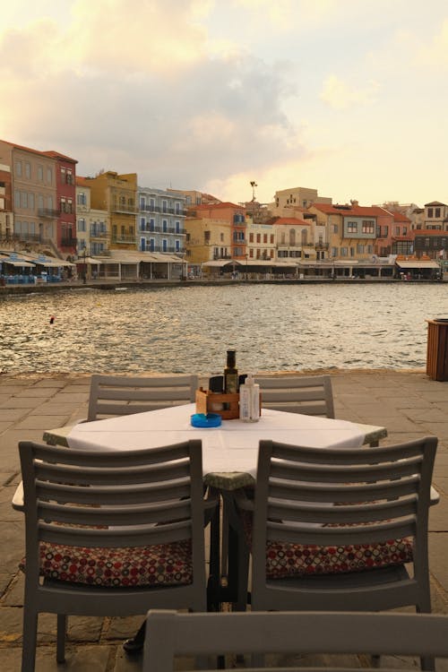 Photo of a Restaurant Table on a Harbor Promenade