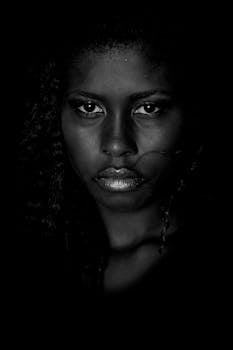 An intense black and white portrait highlighting the emotions of a woman.