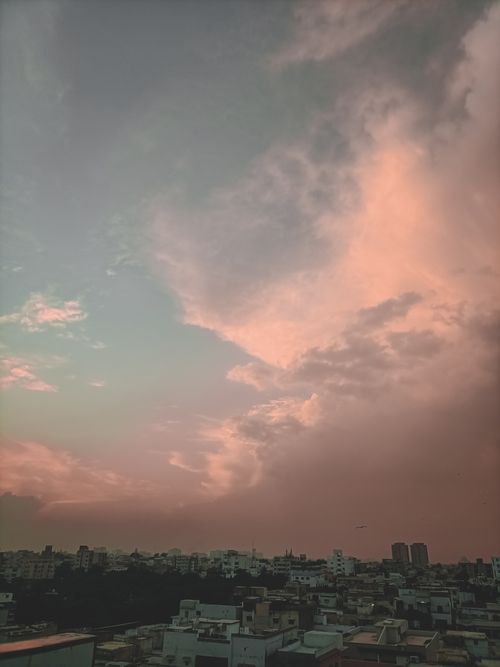 Free Cityscape captured at sunset showing a peaceful urban skyline under pink skies. Stock Photo