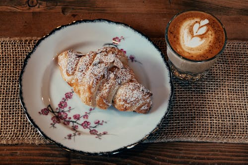 Fresh Croissant and Cappuccino on Table