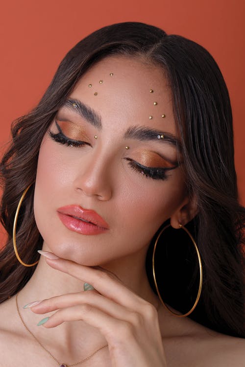 Woman Wearing Gold Hoop Earrings in Close-Up Photography