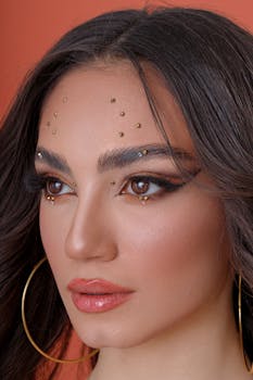 Close-up portrait of a woman with stunning makeup and jewelry for an artistic look.