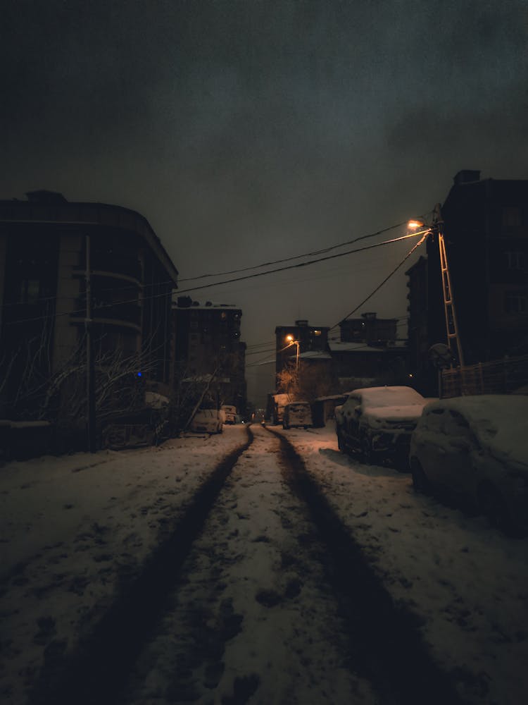 A Snow Covered Road At Night