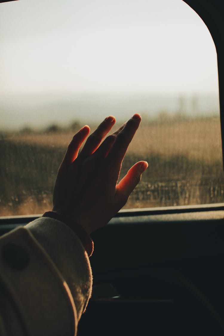 Hand On A Car Window 