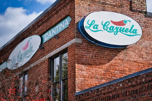 Free Redbrick exterior of La Cazuela cantina in Lawrenceville, GA, showcasing a vibrant urban scene. Stock Photo