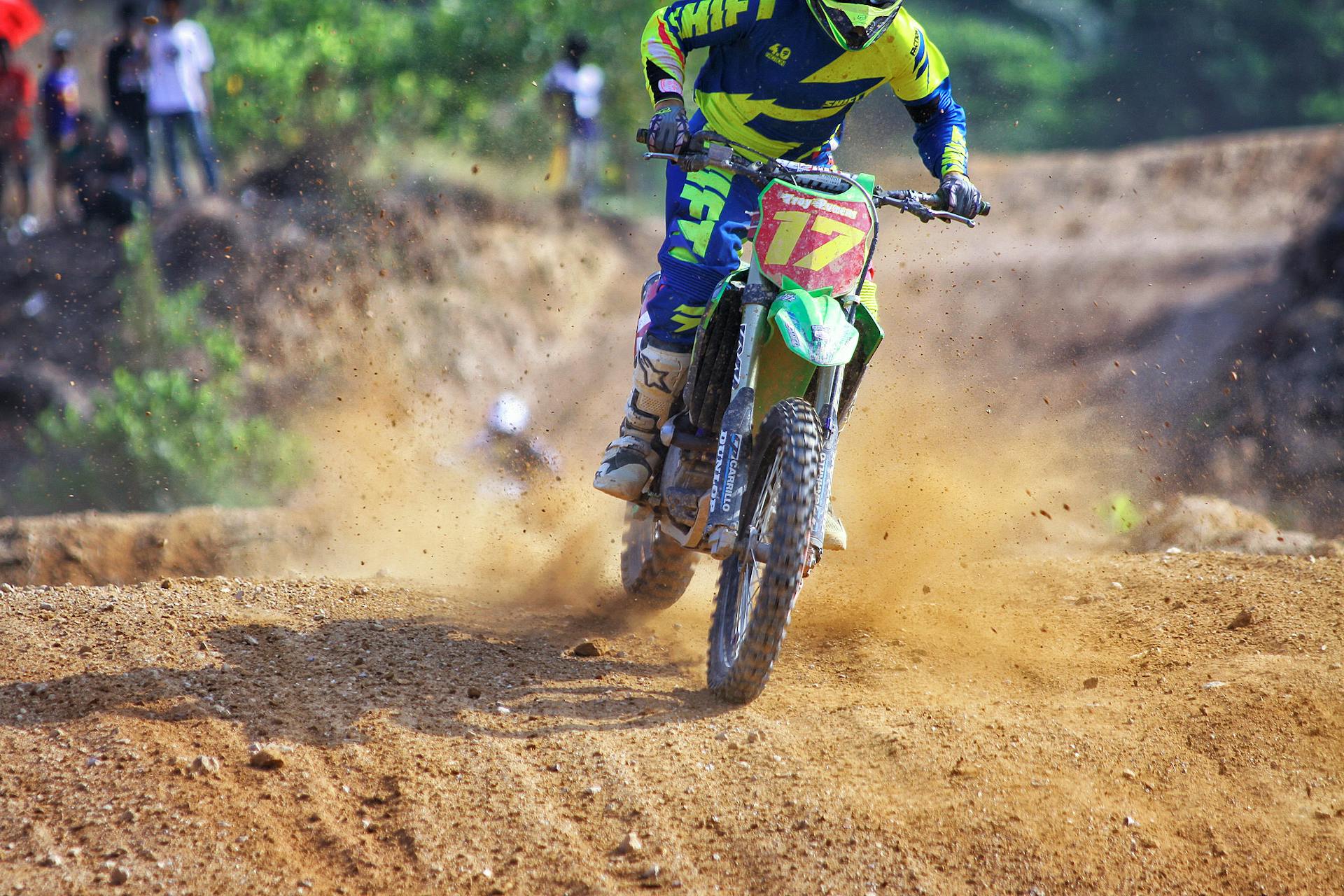 Man Riding Green Dirt Motorcycle during Daytime