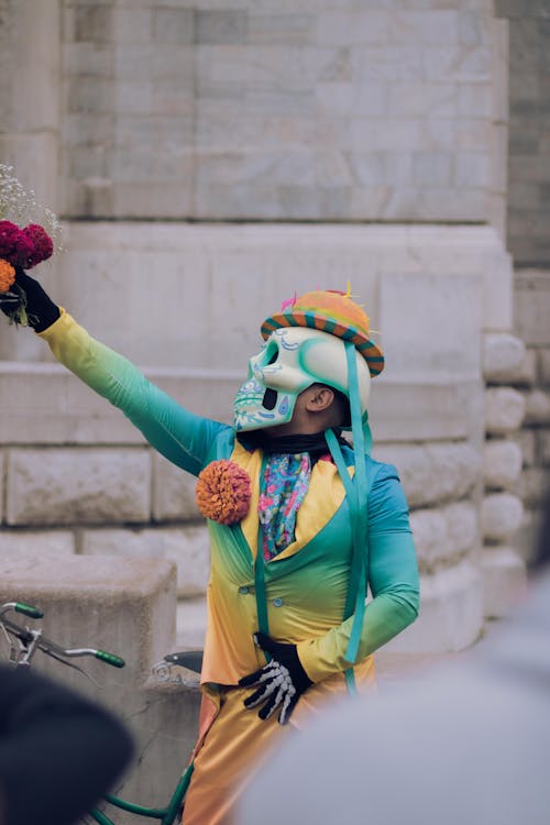 Man with Skull Mask and Yellow Hat on Head