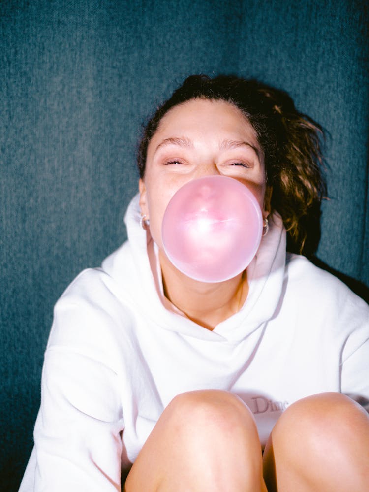 A Woman Blowing A Chewing Gum