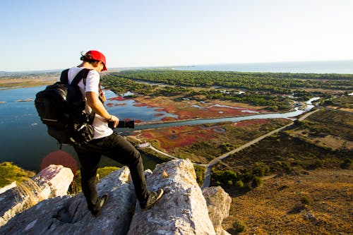 A Person Standing on Rocks on Mountain