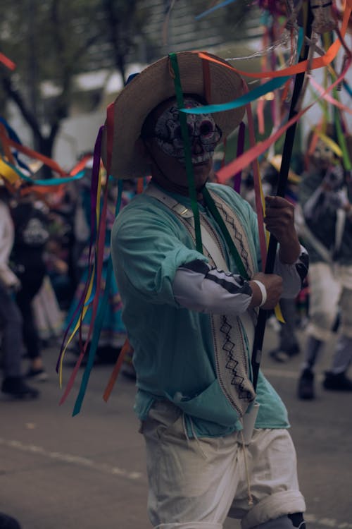 A Man in a Skull Face Paint Holding a Banner